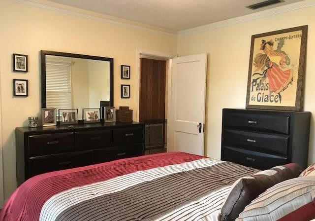 1677 Geraldine Drive Jacksonville, FL 32205 - Photo 33 of 52 a bedroom with a bed and a dresser