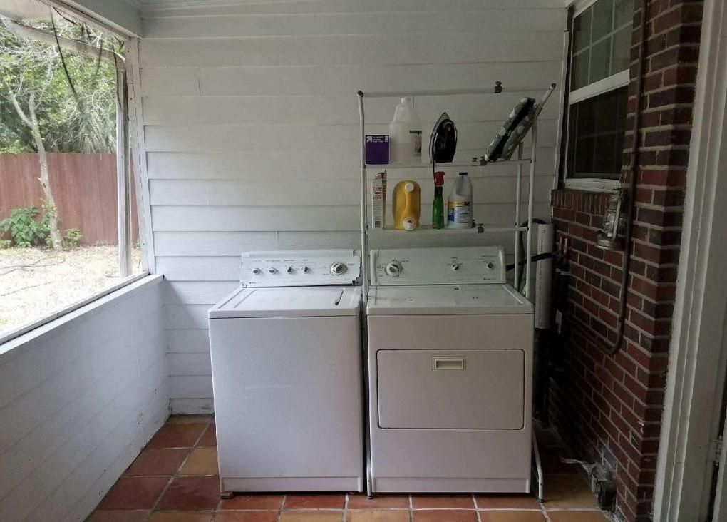 1677 Geraldine Drive Jacksonville, FL 32205 - Photo 37 of 52 a utility room with cabinets washer and dryer