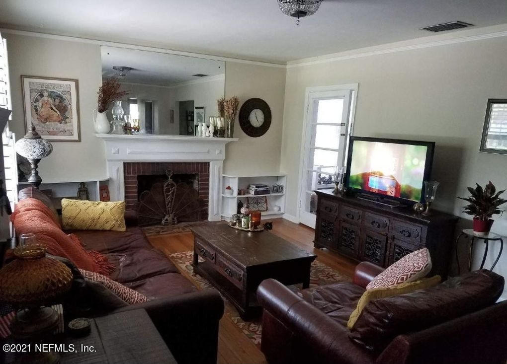 1677 Geraldine Drive Jacksonville, FL 32205 - Photo 8 of 52 a living room with furniture a flat screen tv and a fireplace