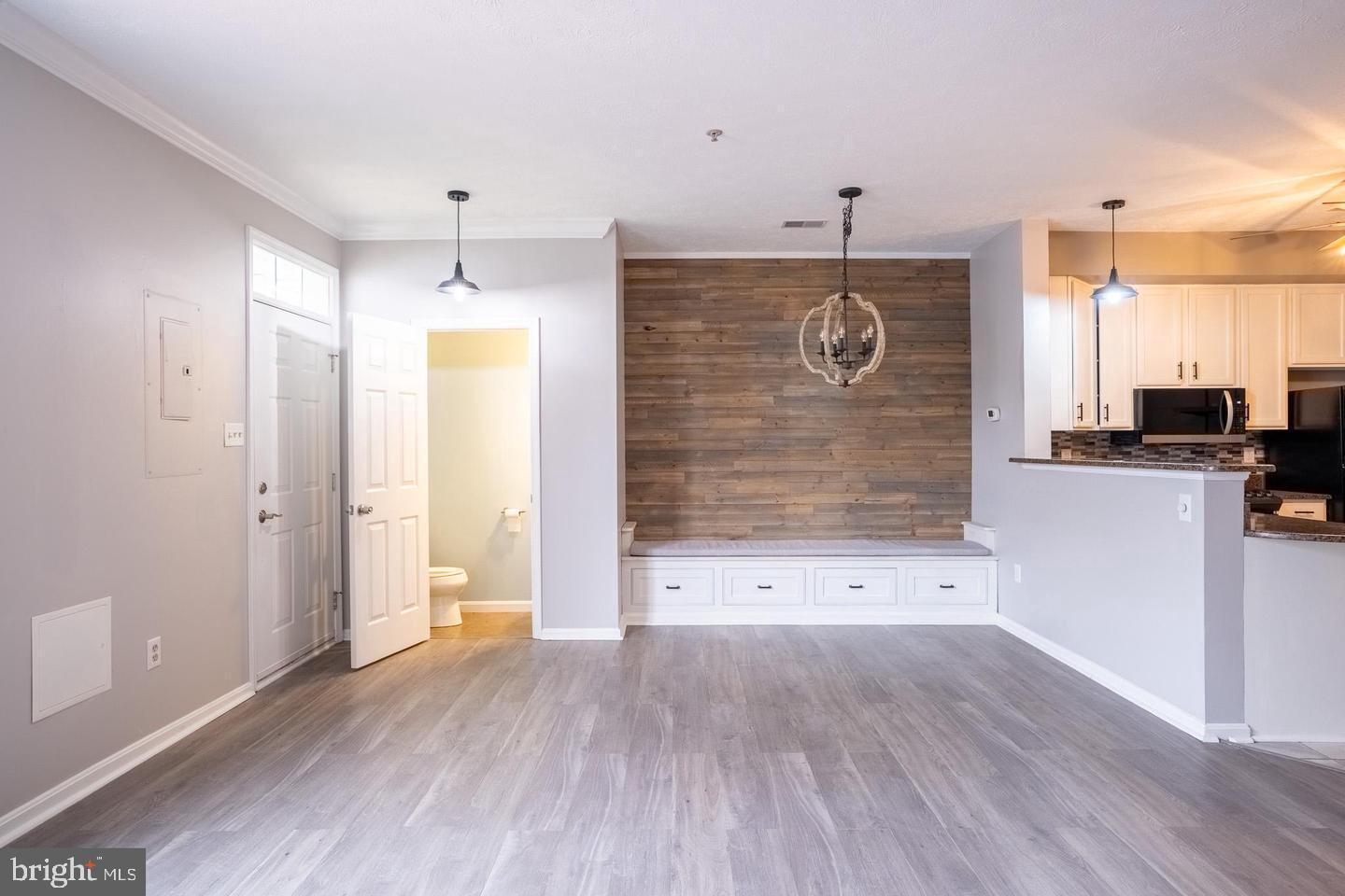 4910 Edgeware Terrace Frederick, MD 21703 - Photo 2 of 9 wooden floor in an empty room with a kitchen