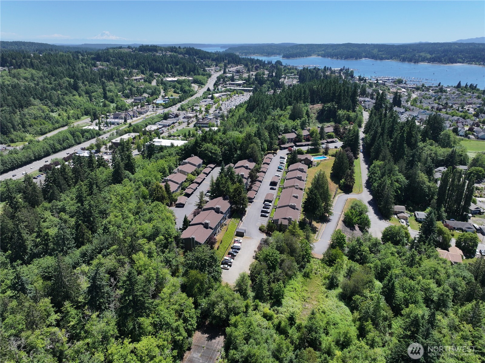 20249 Highway 305 Poulsbo, WA 98370 - Photo 19 of 25 an aerial view of a city with lots of residential buildings and mountain view in back