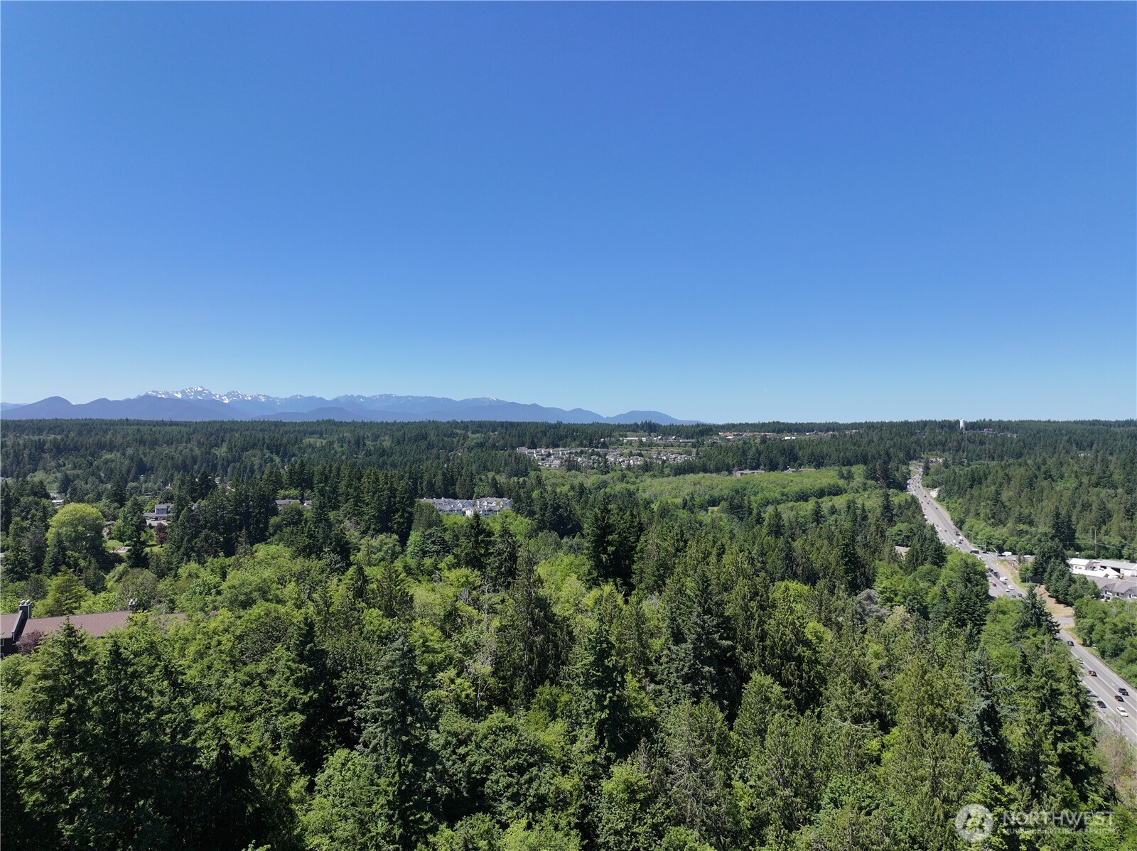 20249 Highway 305 Poulsbo, WA 98370 - Photo 7 of 25 a view of a city with lush green forest
