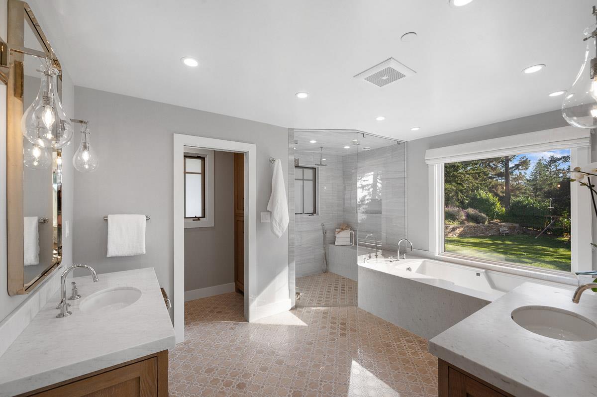 220 Ware Road Woodside, CA 94062 - Photo 29 of 59 a large bathroom with a double vanity sink a large mirror and a bathtub