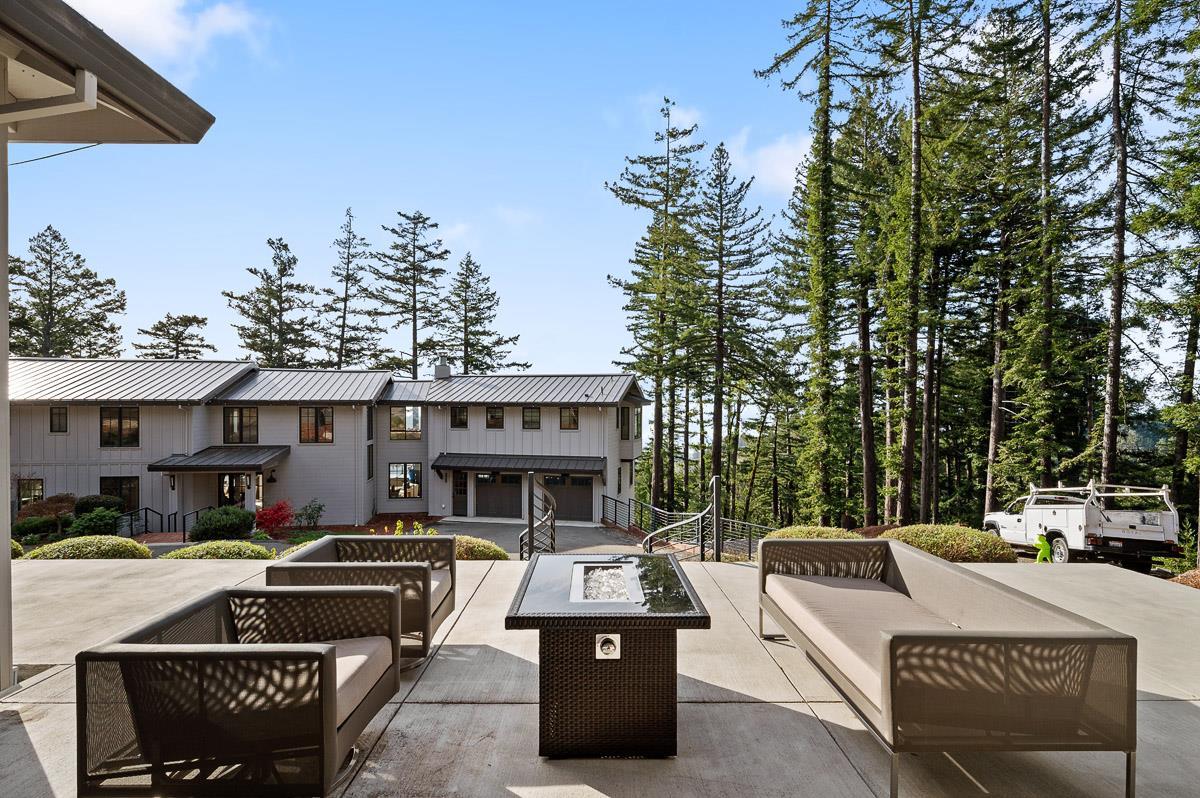 220 Ware Road Woodside, CA 94062 - Photo 57 of 59 a view of a patio with couches table and chairs under an umbrella