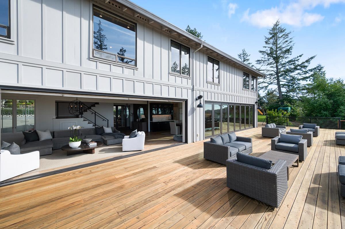 220 Ware Road Woodside, CA 94062 - Photo 8 of 59 a view of a patio with couches table and chairs with wooden floor and fence