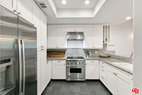 a kitchen with a stove sink and refrigerator