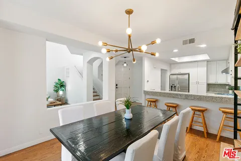 a view of a kitchen area kitchen island dining table and chairs