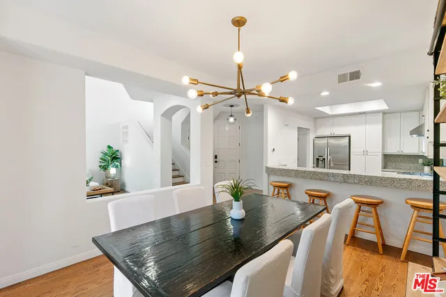 a view of a kitchen area kitchen island dining table and chairs