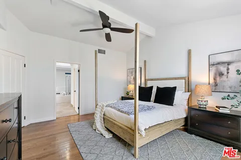 a bedroom with a bed and a night stand