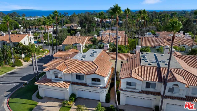 a view of a balcony with wooden floor and fence