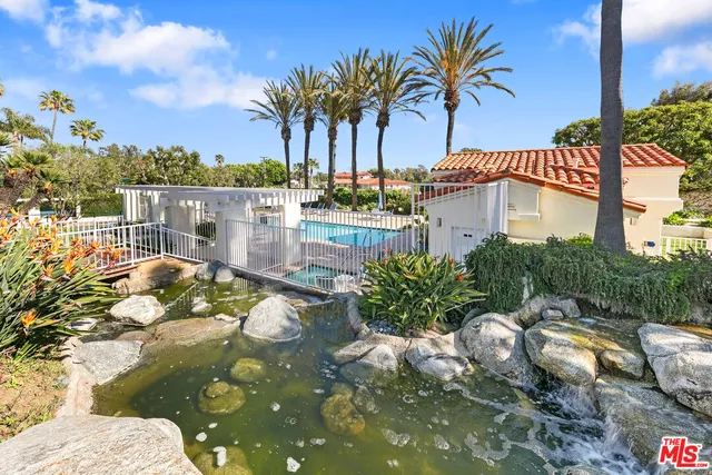 a view of a garden with a building in the background
