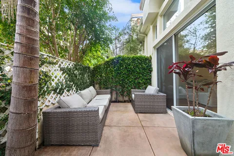 a view of patio with couches and potted plant