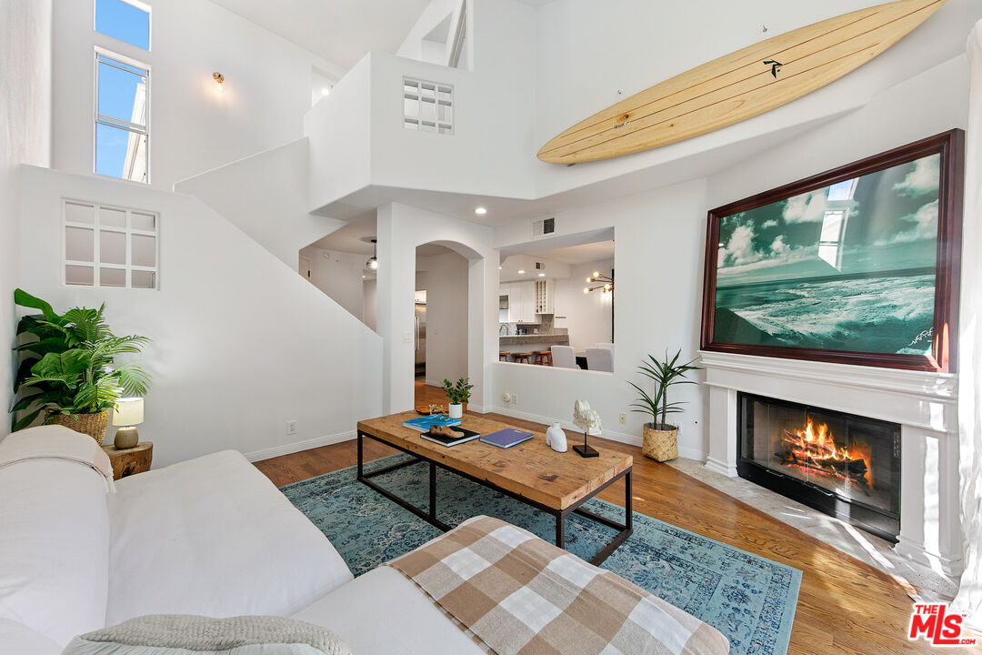 6477 Zuma View Place, Unit 125 Malibu, CA 90265 - Photo 9 of 33 a living room with furniture a flat screen tv and a fireplace