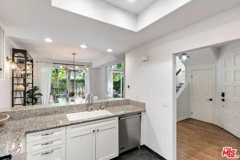 a kitchen with granite countertop a sink and a window