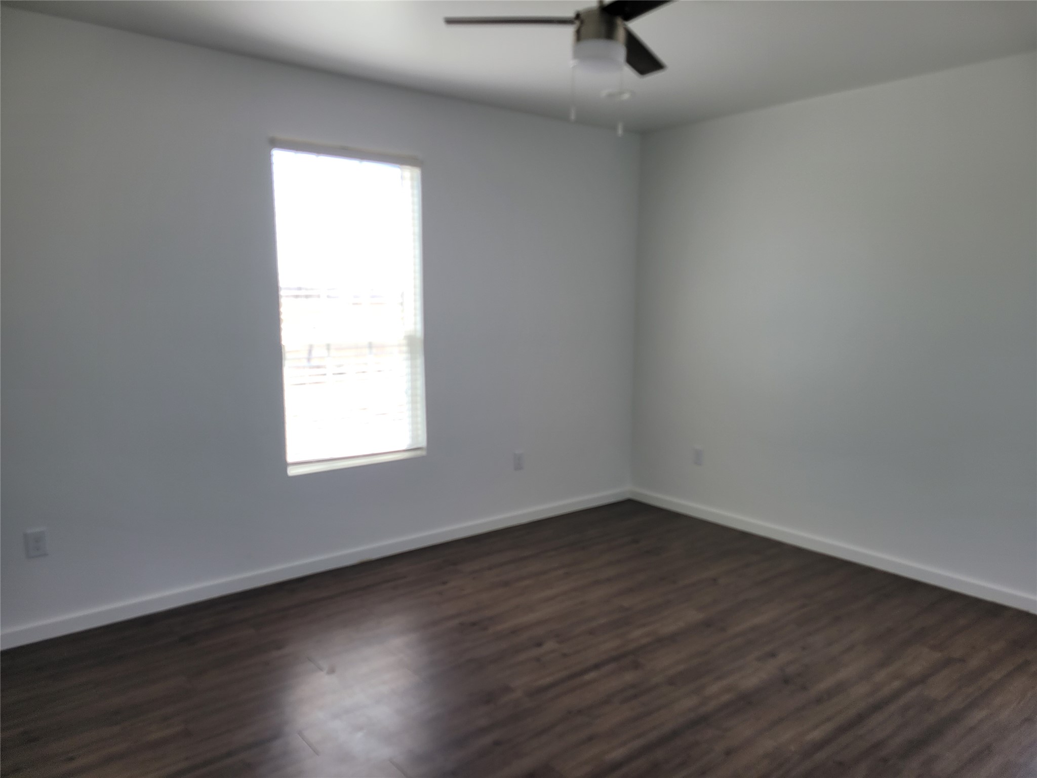 422 A Road Stockdale, TX 78160 - Photo 16 of 40 Wood flooring and clean walls highlight this naturally illuminated space, ready for personalization.