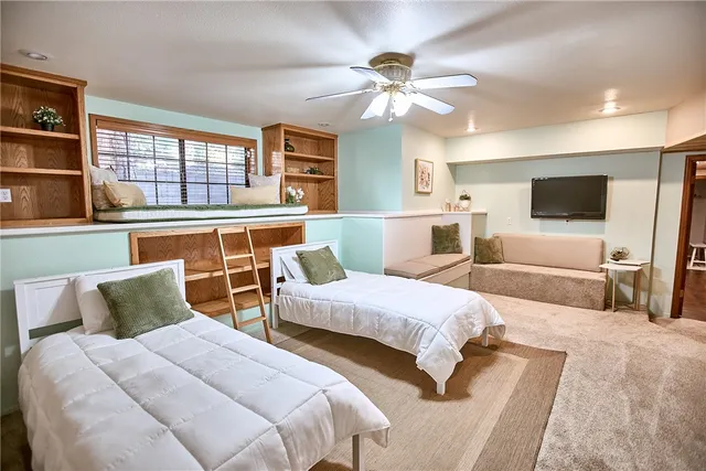 an aerial view of residential house with parking and yard