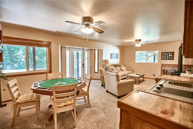 a roof deck with table and chairs under an umbrella
