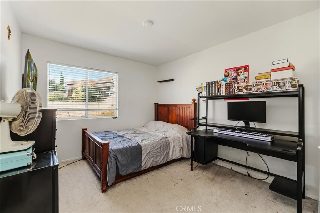 352 Leafwood Court Riverside, CA 92506 - Photo 32 of 42 a bedroom with a bed furniture and a flat screen tv