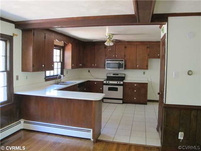 1994 Shallow Well Road Manakin-Sabot, VA 23103 - Photo 11 of 23 a kitchen with stainless steel appliances a sink a stove and cabinets