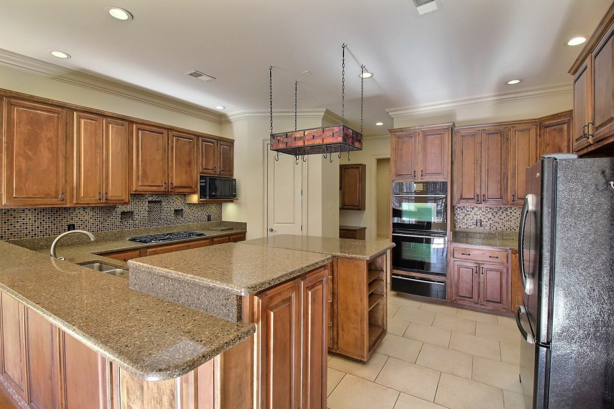 580 Hickory Lake Road Eads, TN 38028 - Photo 15 of 40 a kitchen with stainless steel appliances granite countertop a sink refrigerator and cabinets