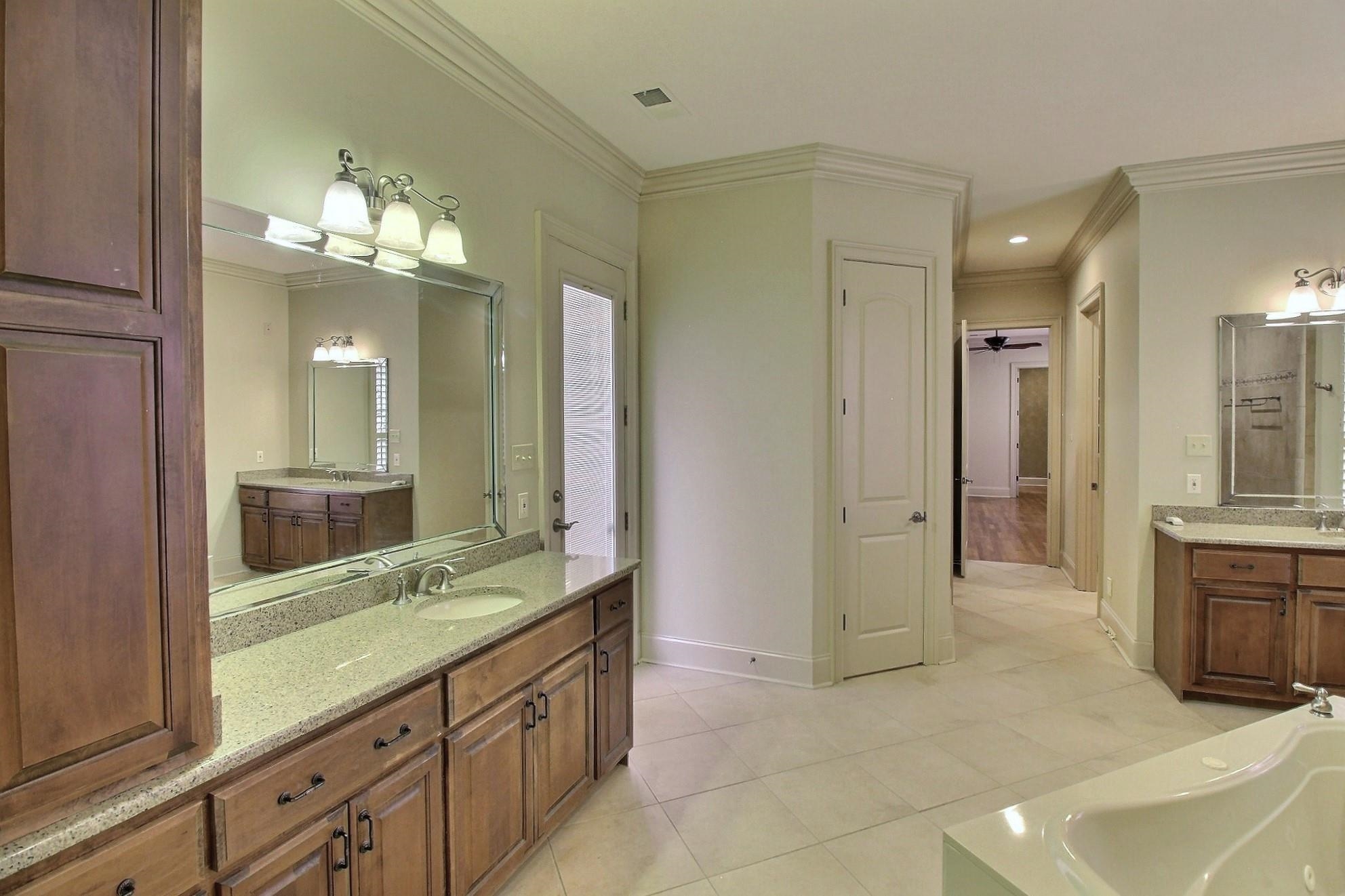 580 Hickory Lake Road Eads, TN 38028 - Photo 25 of 40 a bathroom with a granite countertop sink mirror and a shower