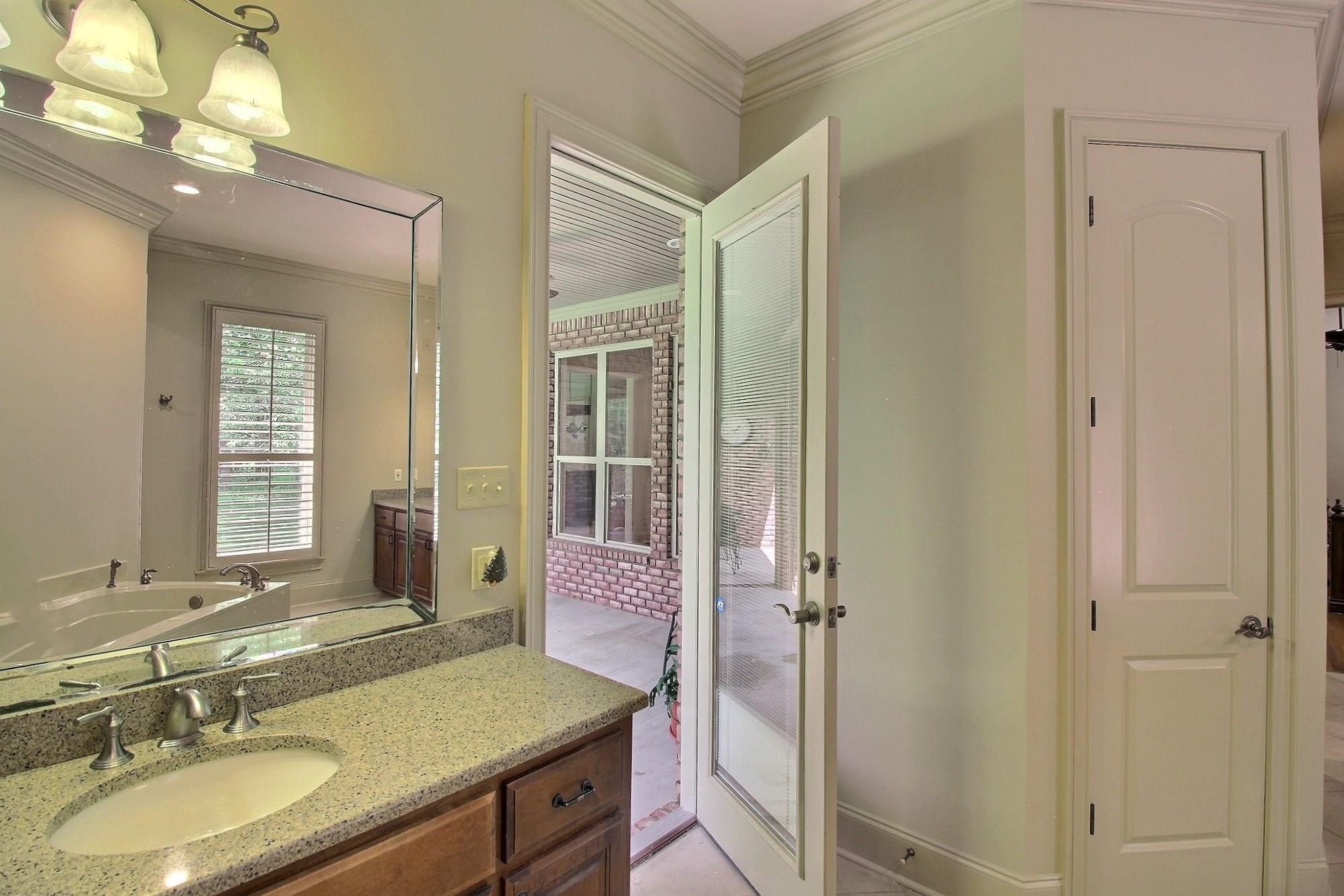 580 Hickory Lake Road Eads, TN 38028 - Photo 28 of 40 a bathroom with a granite countertop sink and a mirror