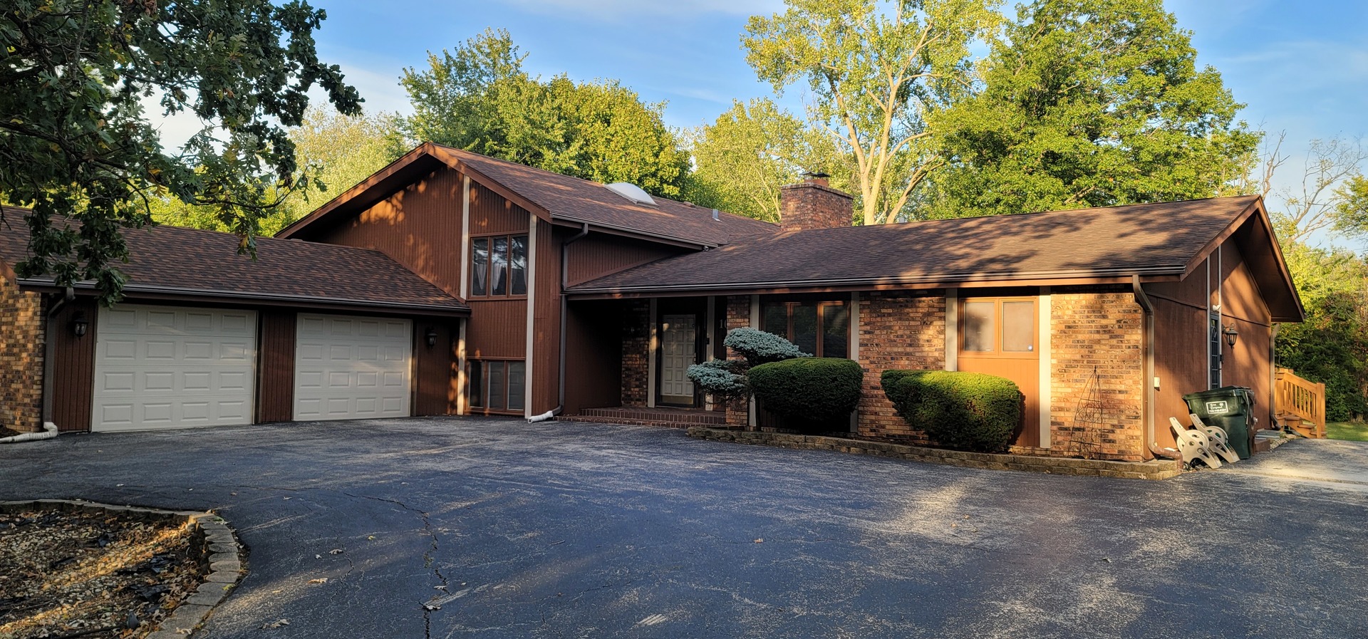 a view of a house with a patio and a yard