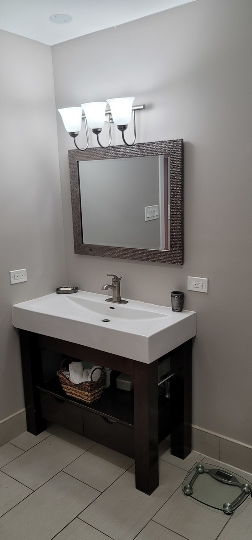1045 Wingate Road Olympia Fields, IL 60461 - Photo 16 of 28 a bathroom with a sink and a mirror