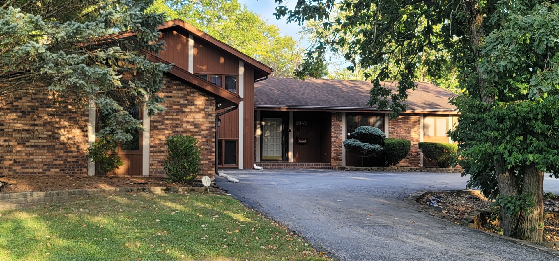 1045 Wingate Road Olympia Fields, IL 60461 - Photo 2 of 28 a front view of a house with a garden and trees