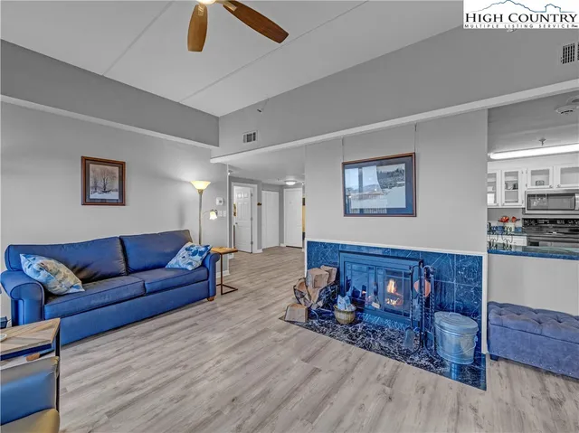 a living room with furniture and wooden floor