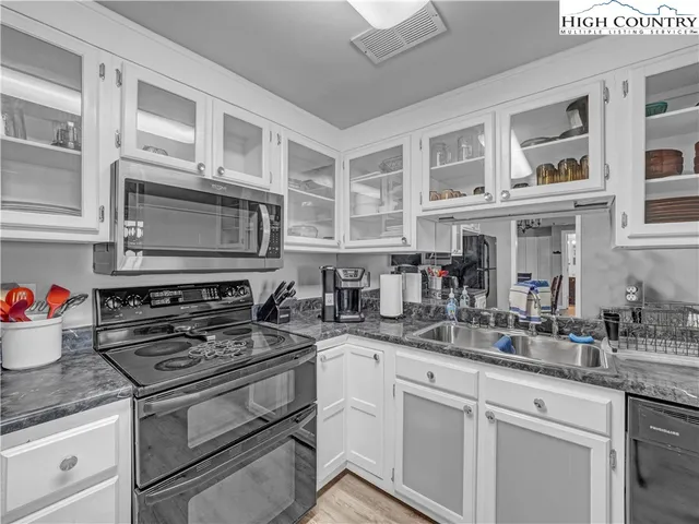 a kitchen with stainless steel appliances granite countertop a stove and cabinets