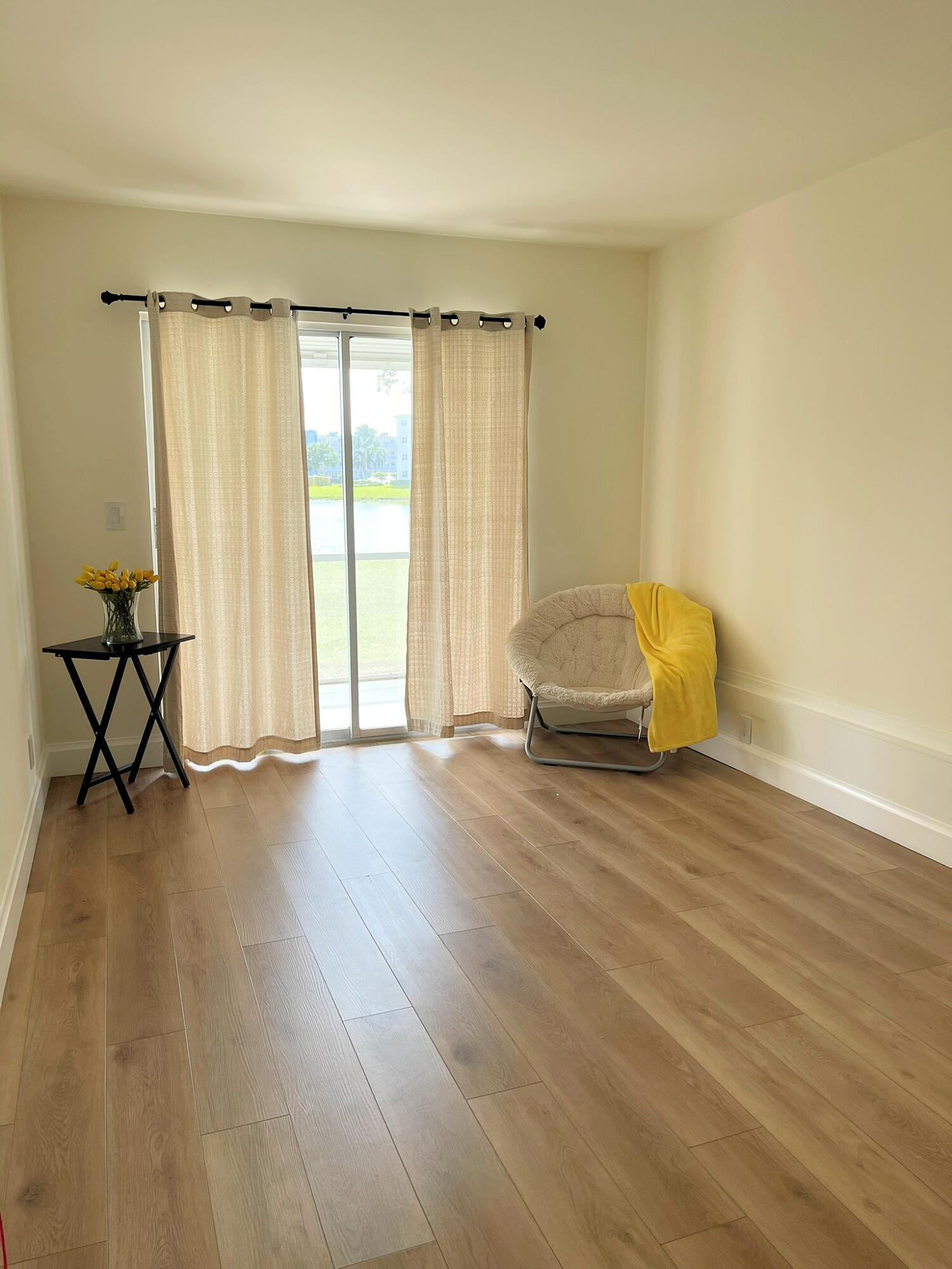 1030 Rexford B Boca Raton, FL 33434 - Photo 19 of 27 an empty room with wooden floor and windows