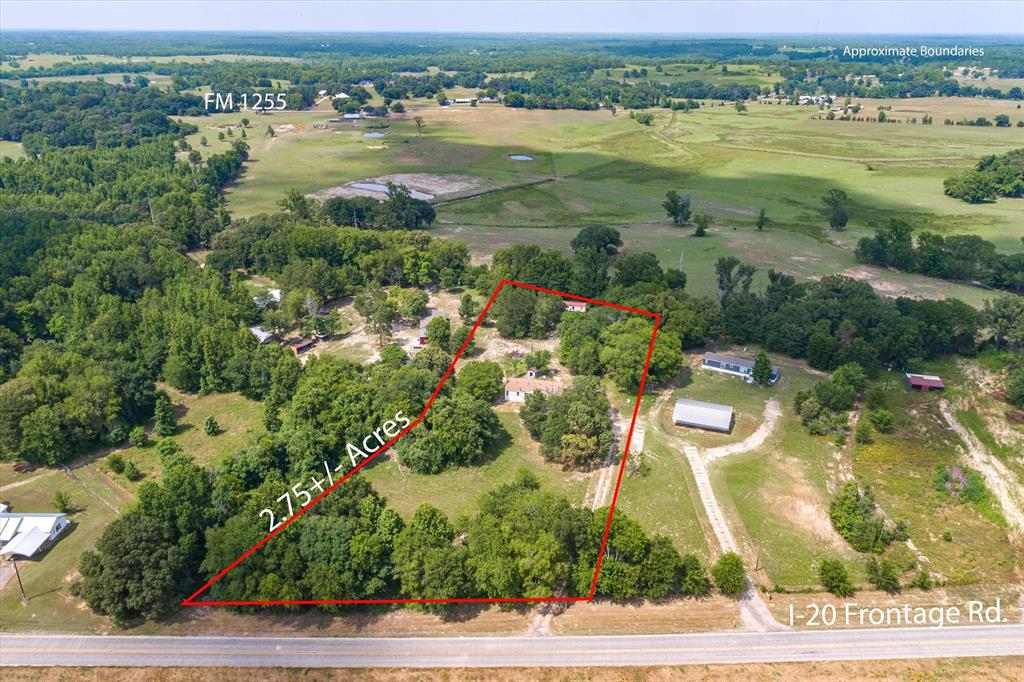 an aerial view of ocean with residential house and outdoor space