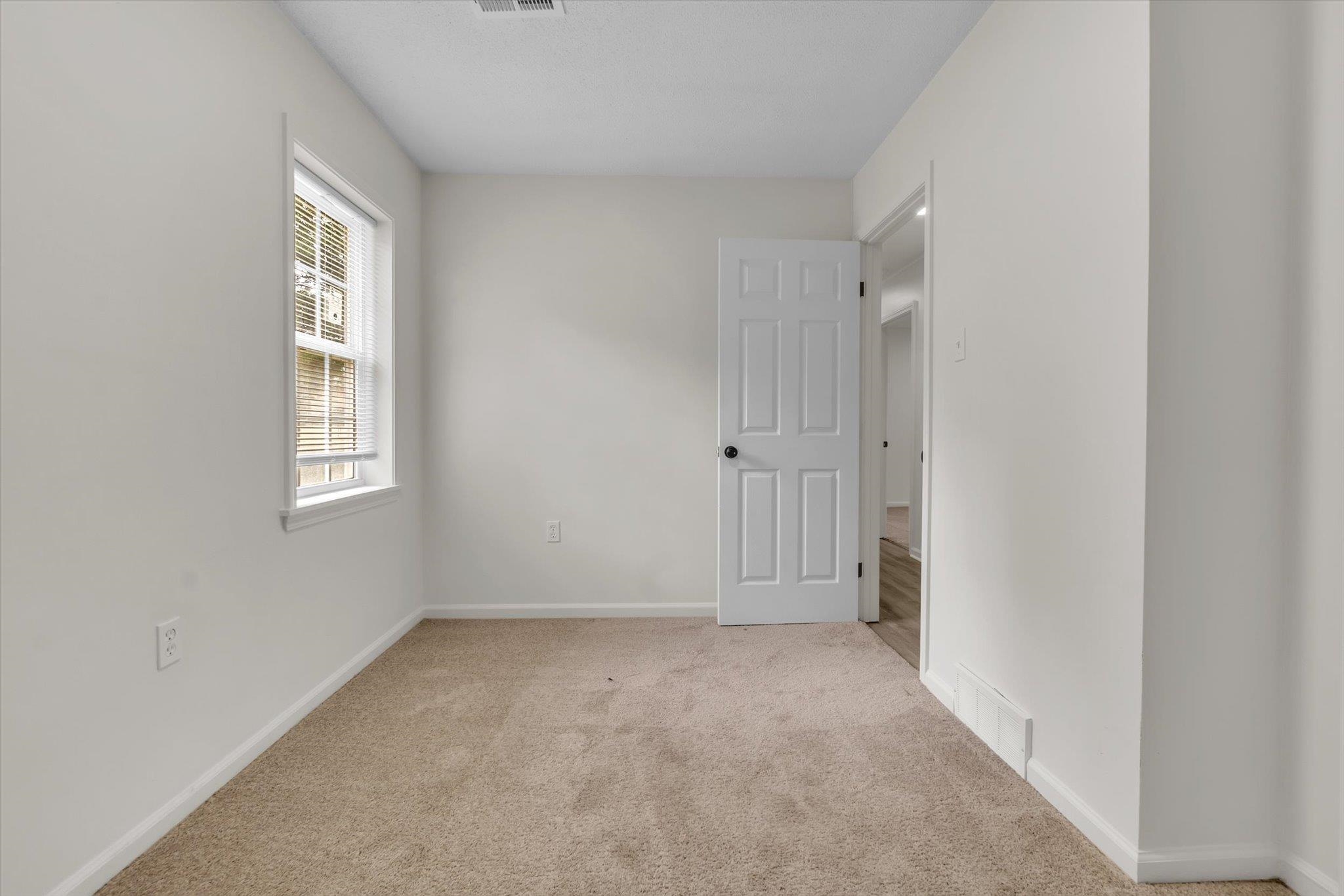 129 Tatlock Circle Covington, TN 38019 - Photo 11 of 16 Empty room featuring baseboards and light colored carpet