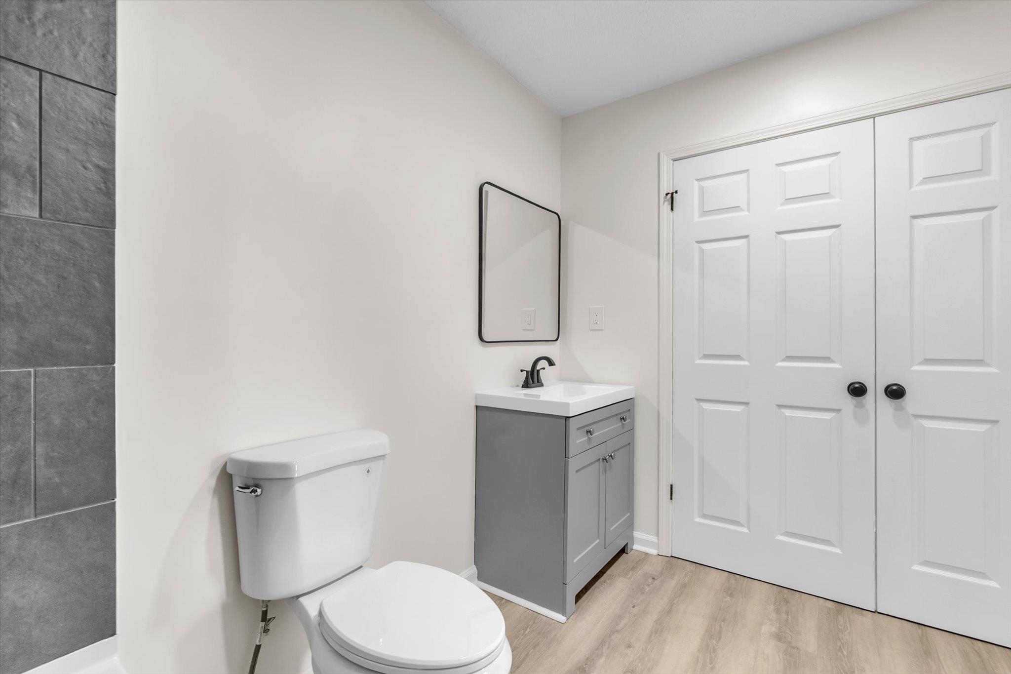 129 Tatlock Circle Covington, TN 38019 - Photo 13 of 16 Half bathroom with vanity and light wood-type flooring