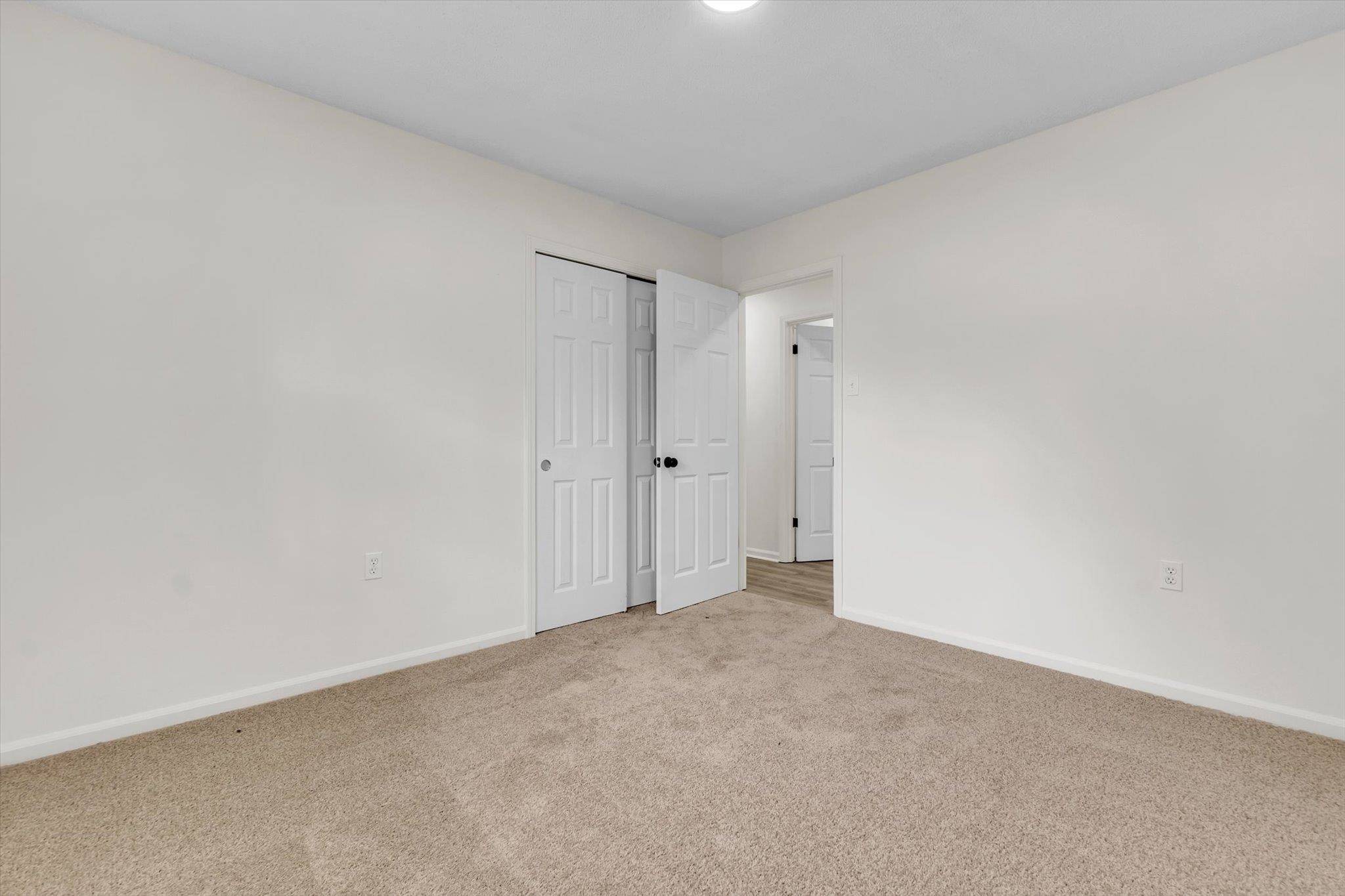 129 Tatlock Circle Covington, TN 38019 - Photo 9 of 16 Unfurnished bedroom with light colored carpet and a closet