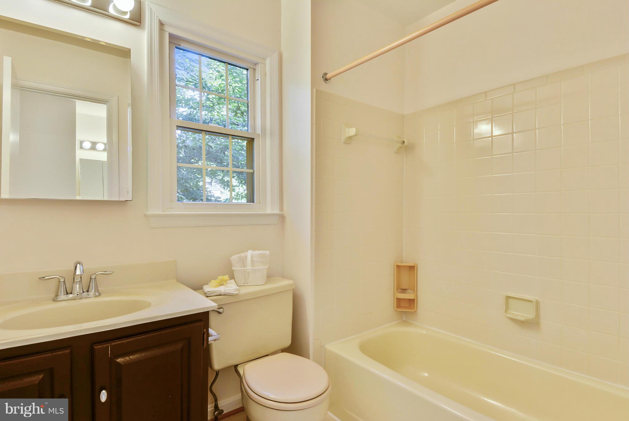 10611 Margate Road Silver Spring, MD 20901 - Photo 17 of 30 a bathroom with a bathtub shower sink vanity mirror and toilet