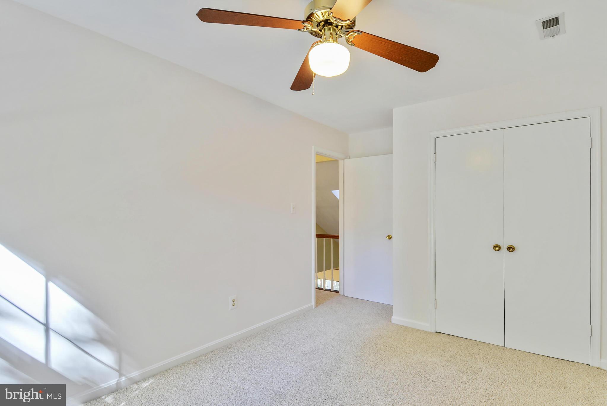 10611 Margate Road Silver Spring, MD 20901 - Photo 18 of 30 a view of an empty room with a chandelier fan