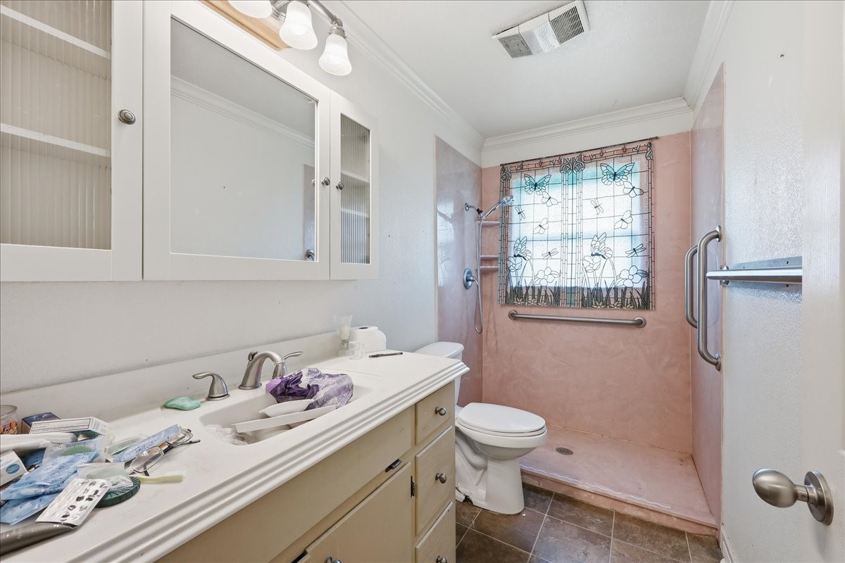 150 Gary Street Bridge City, TX 77611 - Photo 9 of 12 Bathroom featuring vanity, sink, and shower/tub combination.