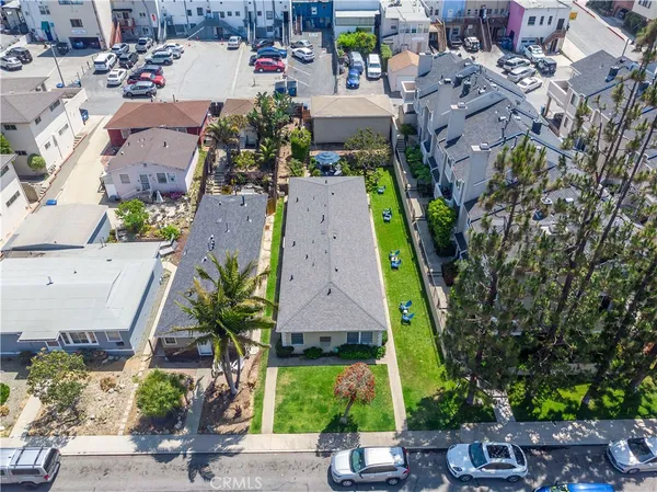 an aerial view of a house with garden space and street view