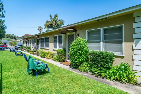 a garden with trees in front of it