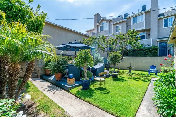 a view of a backyard with plants and a patio