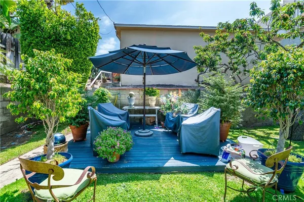 a view of a chairs and table in the backyard