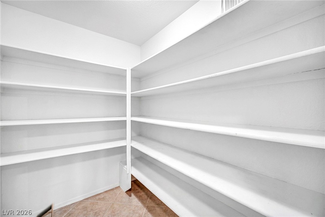 10730 Amber Ridge Drive, Unit 101 Las Vegas, NV 89144 - Photo 27 of 32 Ample built-in shelving lines this functional closet, providing abundant storage space for all your needs.