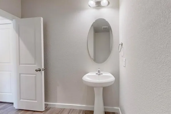 a kitchen with granite countertop a sink a counter top space stainless steel appliances and cabinets