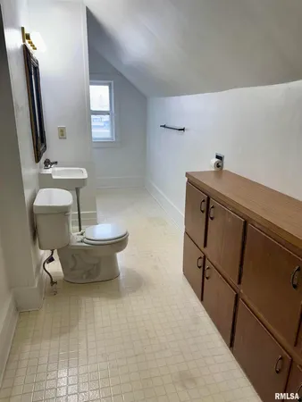 a bathroom with a sink toilet and mirror