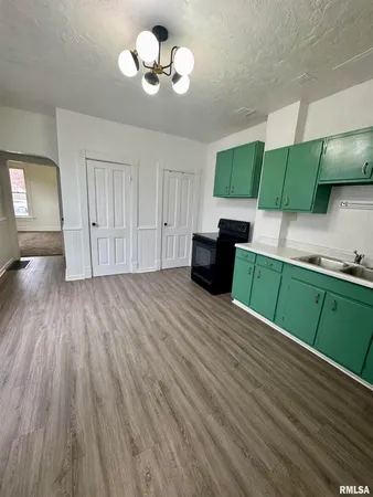 a view of a kitchen with a dishwasher cabinets and a wooden floor