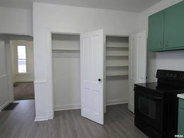 a kitchen with a refrigerator and a stove top oven