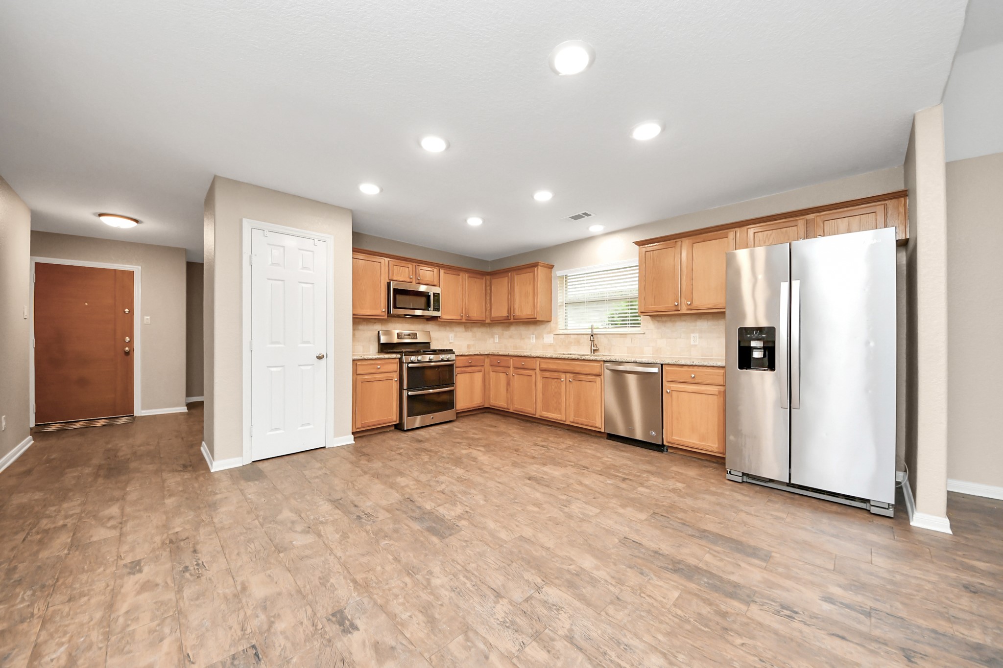 14610 Hazy Ridge Lane Cypress, TX 77429 - Photo 25 of 44 Beautiful kitchen featuring abundant cabinetry, ample storage space, and a refrigerator that complements the home's functional and inviting design.