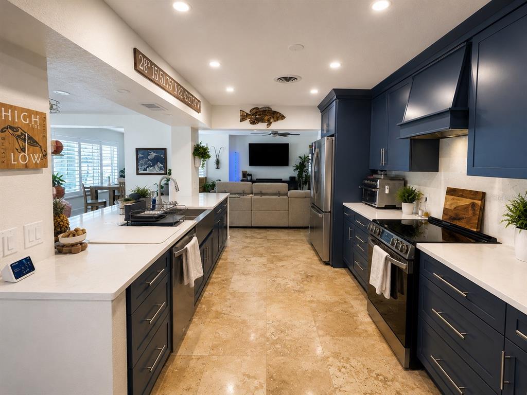 5431 Foley Square New Port Richey, FL 34652 - Photo 15 of 39 a large kitchen with stainless steel appliances and a stove top oven